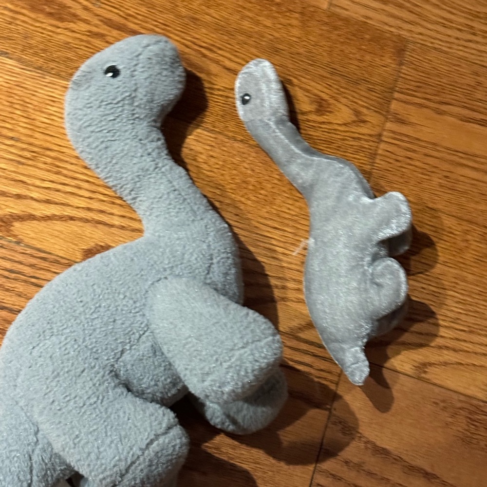 Two plush dinosaurs